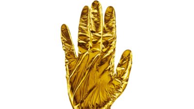a gold gloved hand is held up in a stop gesture.