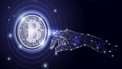 A hand reaches across the cosmos to touch a bitcoin in the stars