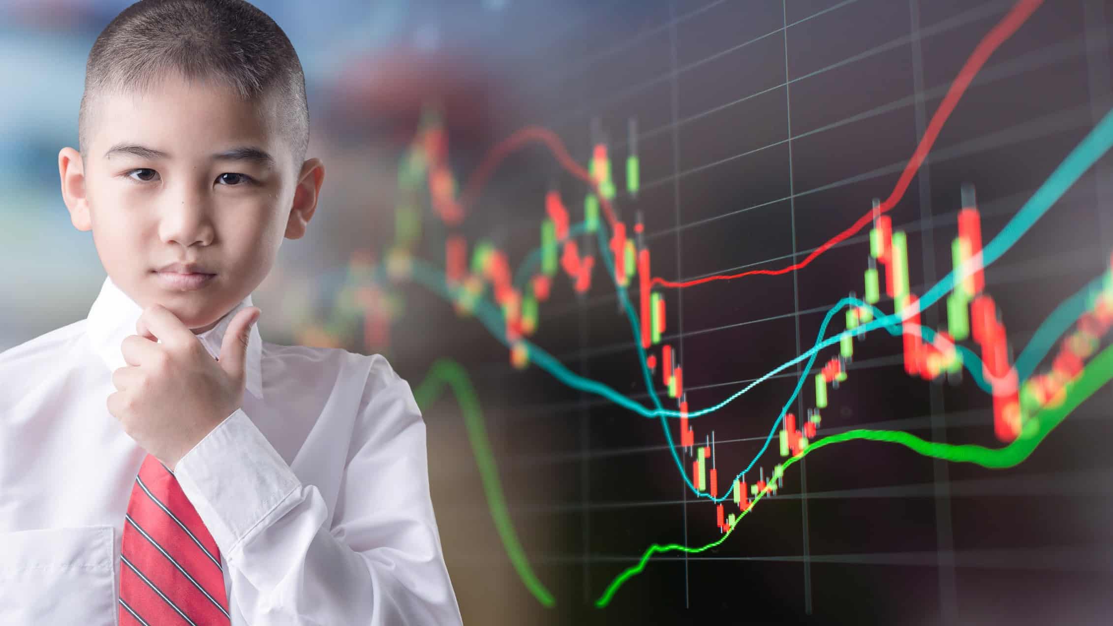 Boy looks quizzical standing in front of a graph.
