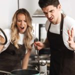 Displeased and shocked emotional young friends cooking in the kitchen.