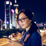 Woman using Facebook on her smartphone.