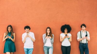 Group of friends using their smartphones.