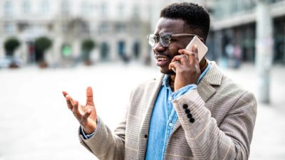 A man talking on his mobile phone looks uncertain