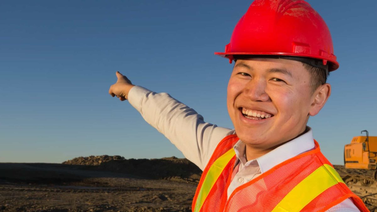 A happy miner pointing.