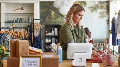 Woman using Square at the counter of a shop.