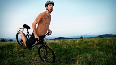 A cyclist using carbon fibre wheels hits a bump and starts to fall and crash.