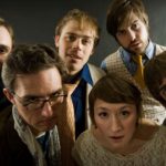 A group of people look intently towards the camera as though they are very interested in the information they are hearing.