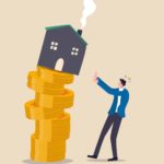 A graphic image of a pile of gold coins balanced precariously with a house on top with smoke coming out of the chimney and a human figure with hands up as if to shield himself from the prospect of the house falling.