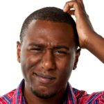 A man with a perplexed expression on his face scratches his head feeling confused about the Hot Chili share price