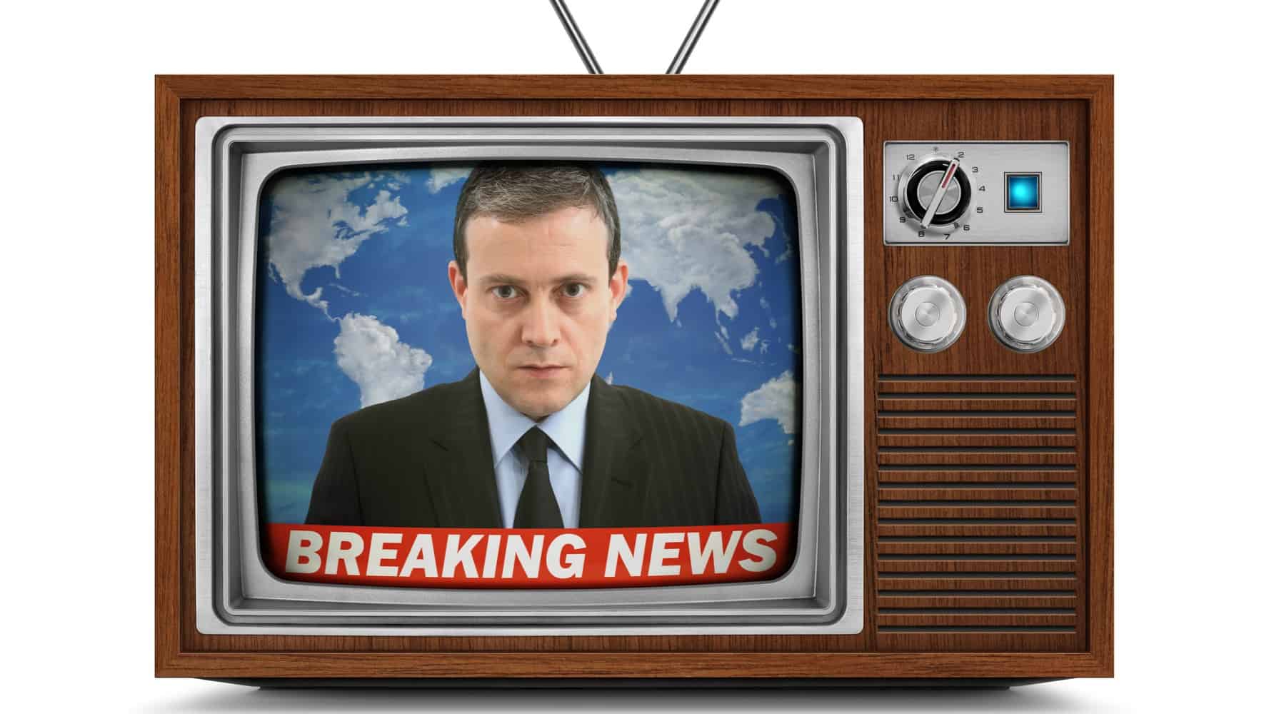 a newscaster appears in front of a world map with a 'Breaking News' flashing at the bottom of the screen of an old fashioned television receiver with dials.