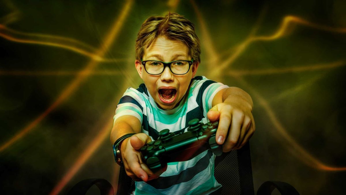 A boy holds on tight as his gaming console nearly blows him away.