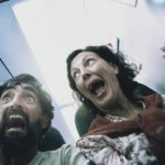 Two passengers freak out in a plane cabin.