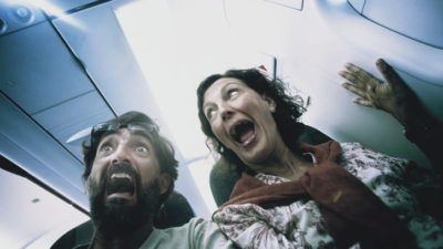 Two passengers freak out in a plane cabin.