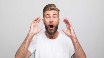 A man has a surprised and relieved expression on his face. as he raises his hands up to his face in response to the high fluctuations in the Galileo share price today