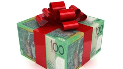 a Christmas present wrapped in one hundred dollar notes and finished with a big red bow