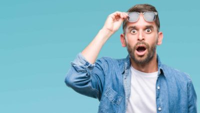 A man holds his glasses up to his forehead looking gobsmacked over ASX share price rises