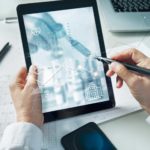 Doctor looks at a graph on a tablet.