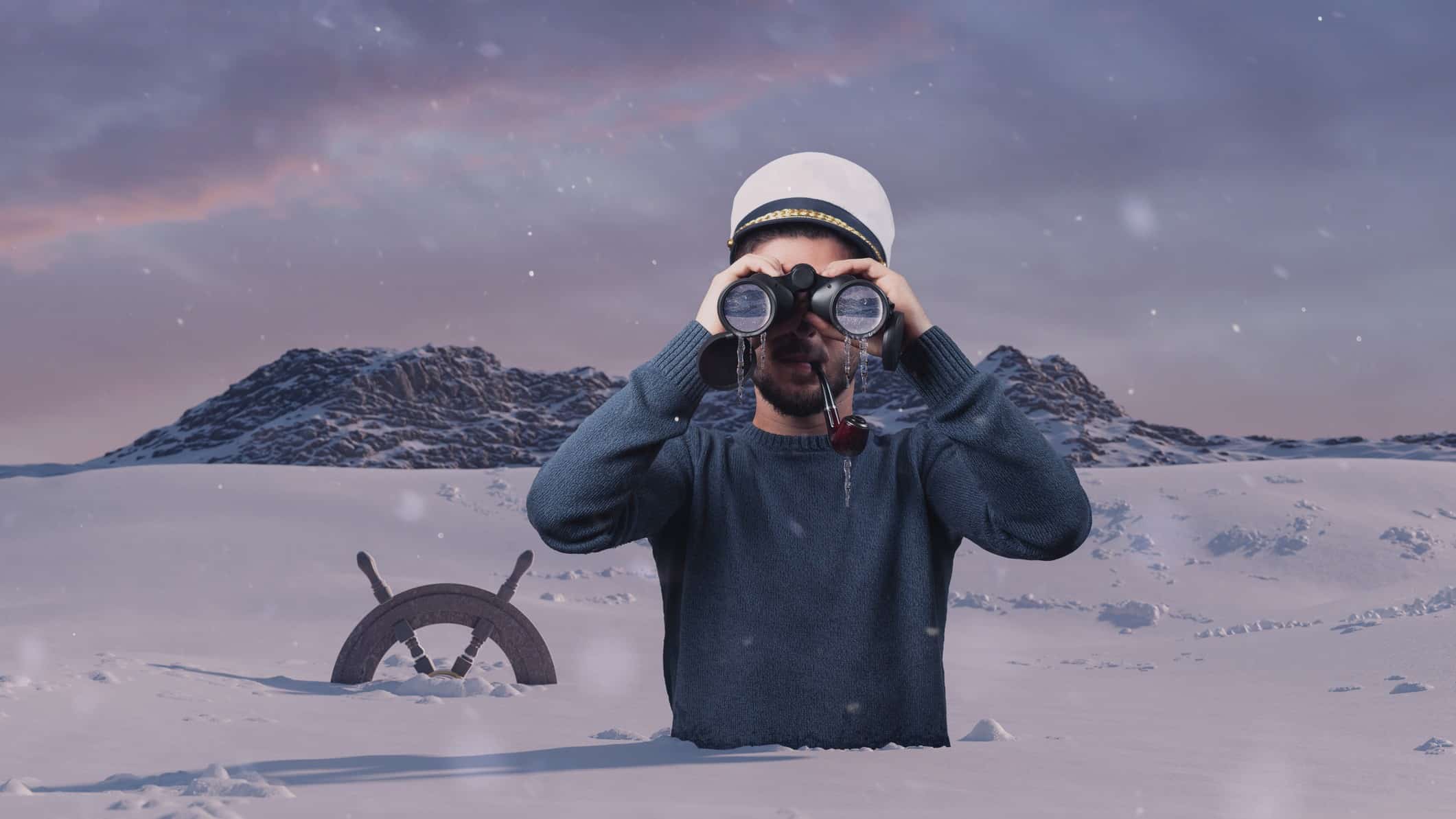 A man stuck up to his waist in snow looks through binoculars