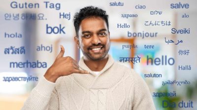 indian man making phone call me gesture over words in foreign languages.