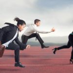 Three business people running a race against each other