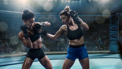Two strong women battle it out in the boxing ring.