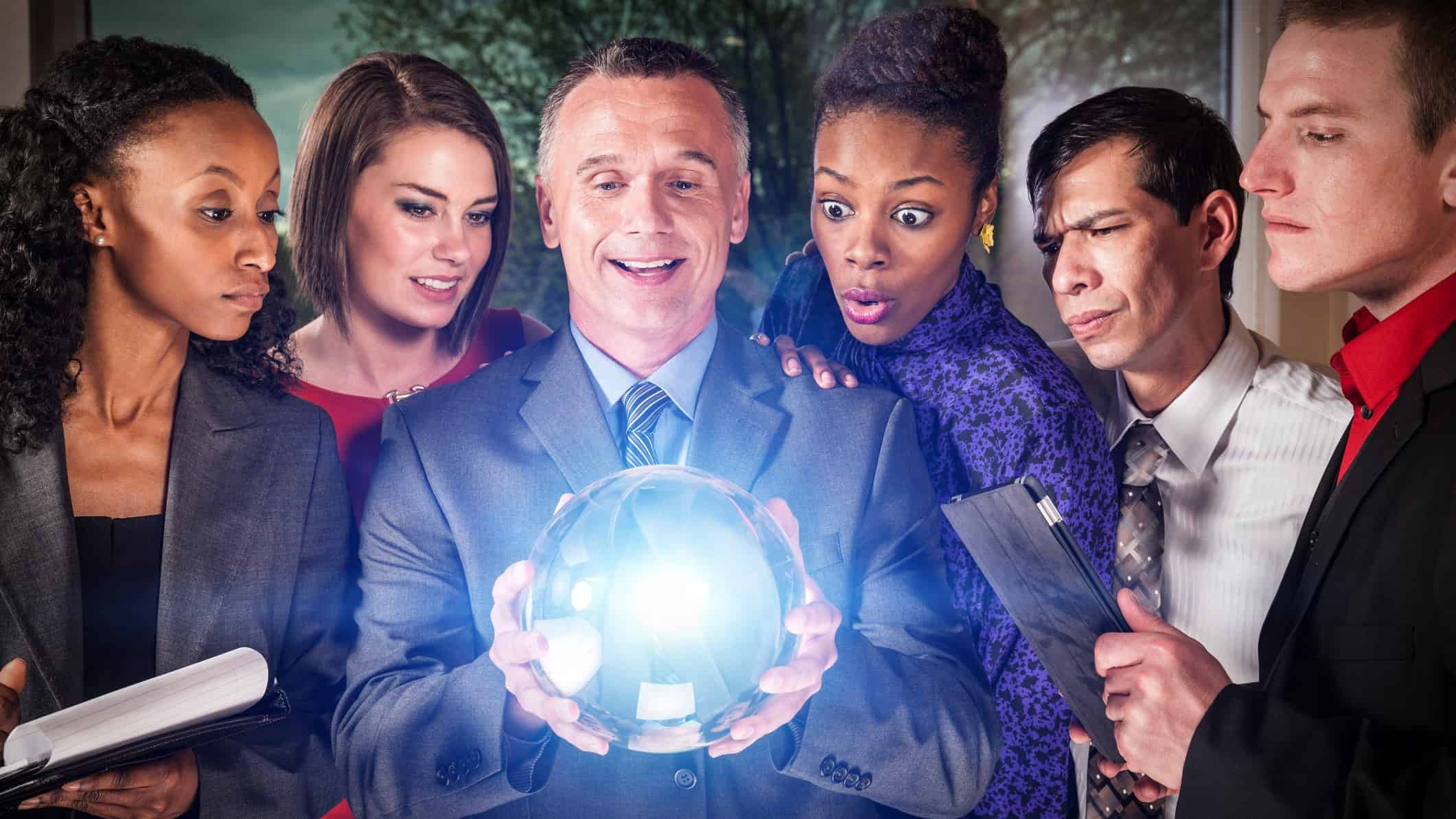 a group of people stand examining a large glowing cystral ball held in the hands of one of the group members while the others regard it with various expressions of wonder, curiousity and scepticism.