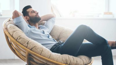 A susccesful person kicks back and relaxes on a comfy chair