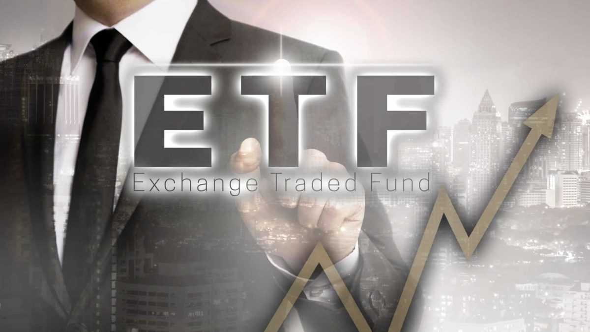 a business person in a suit traces the outline of an upward arrow in a stylised foreground image with the letters ETF and Exchange Traded Funds underneath.