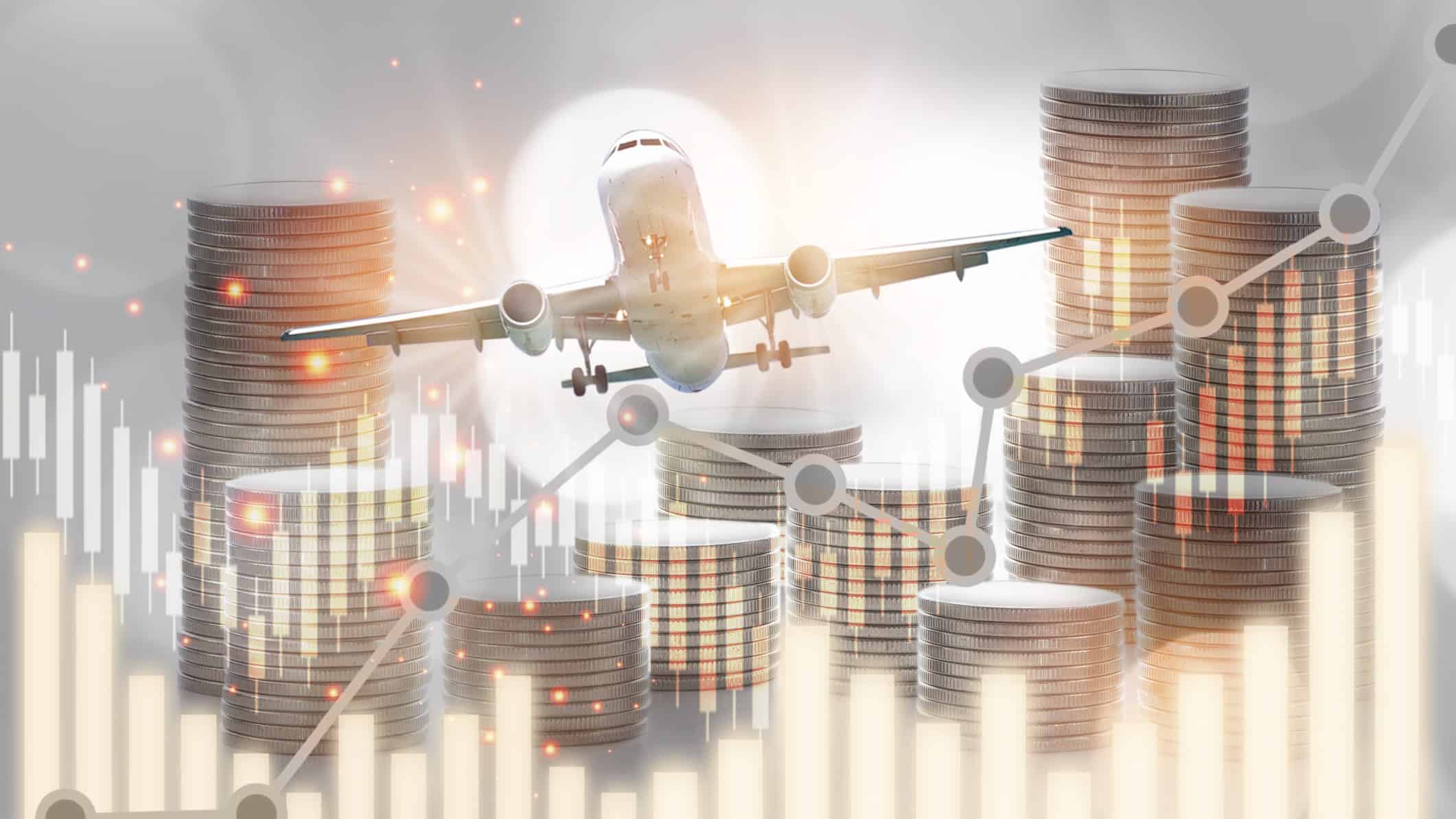 Concept image of a plane flying above a graph and stacks of coins.