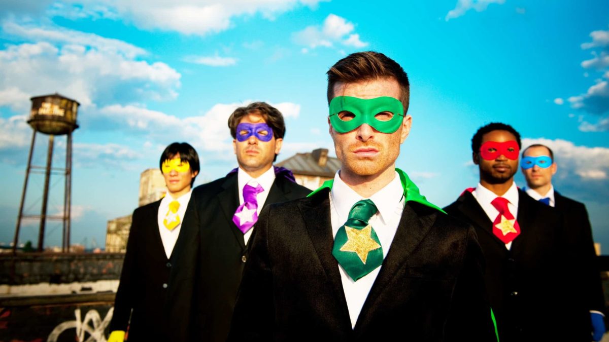 Five guys in suits wearing brightly coloured masks, they are corporate superheroes.