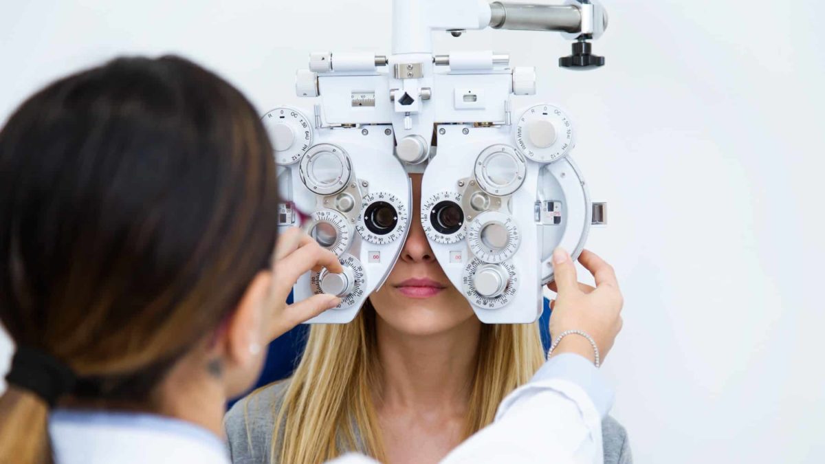 A women has her eyes checked at the optometrist.