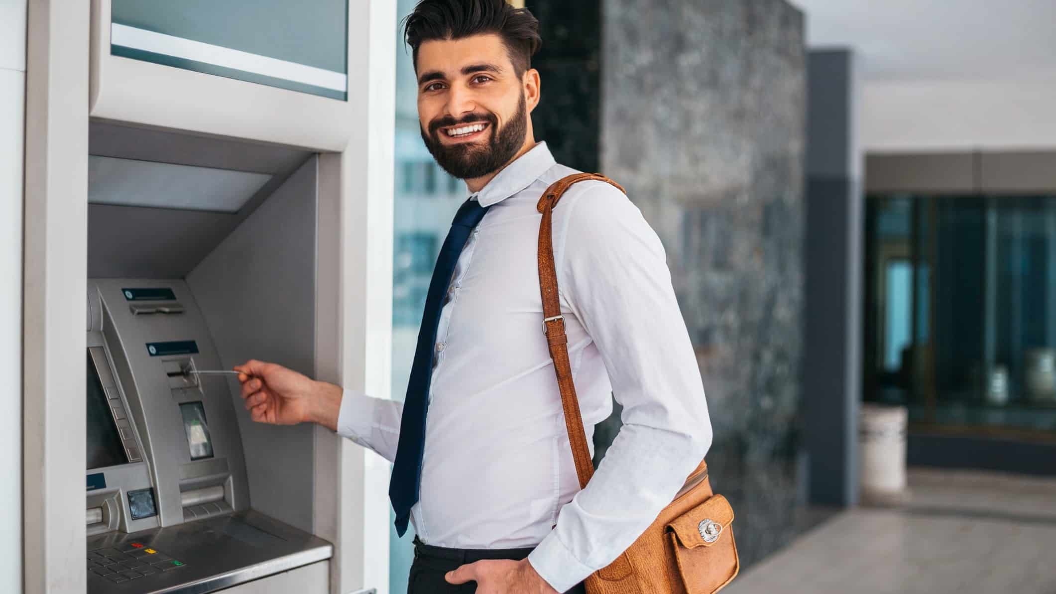 Happy man at an ATM.