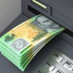 ATM with Australian hundred dollar notes hanging out.