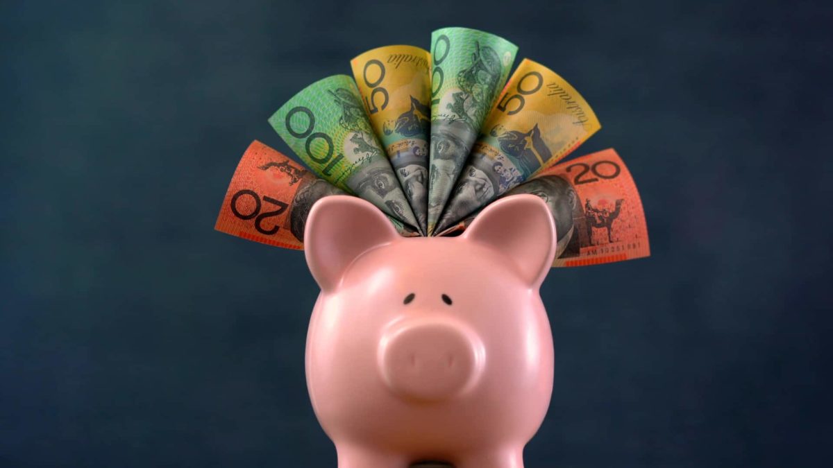 Australian dollar notes around a piggy bank.