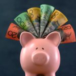 Australian dollar notes around a piggy bank.