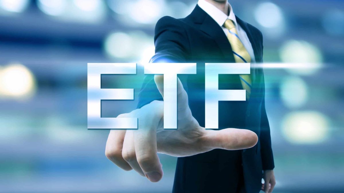 The letters ETF with a man pointing at it.
