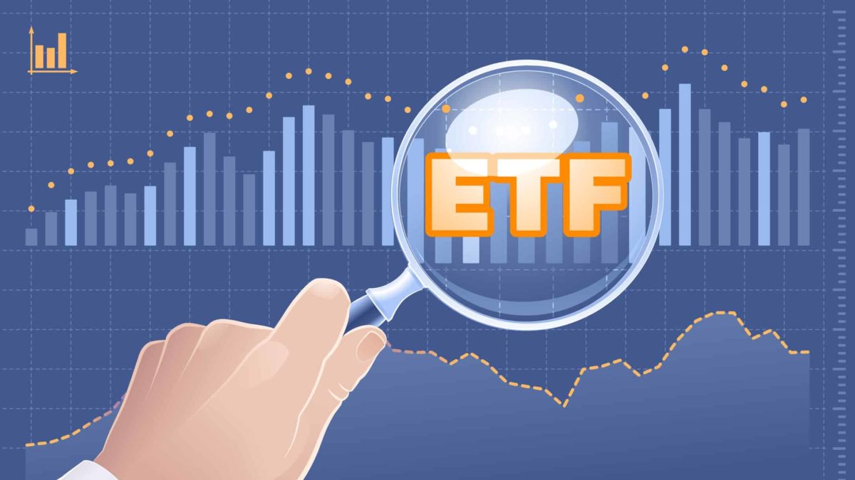 The letters ETF sit in orange on top of a chart with a magnifying glass held over the top of it