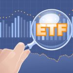 The letters ETF sit in orange on top of a chart with a magnifying glass held over the top of it