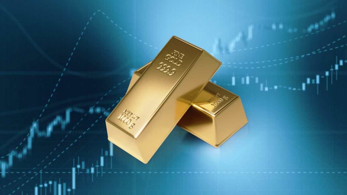 Gold bars with a share price chart in the background.