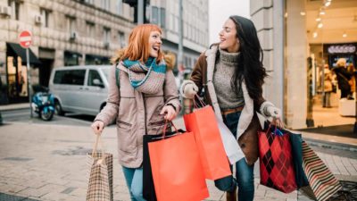 Two happy shoppers walking together.