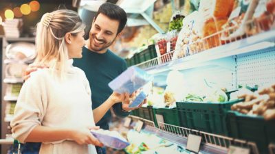 Happy couple doing grocery shopping together.