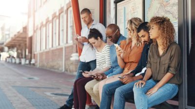 Ordinary Australians waiting at the bus stop using their phones to trade ASX 200 shares today