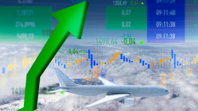 Rising green arrow with a plane in the sky.