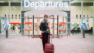Woman at a departure terminal at an airport.