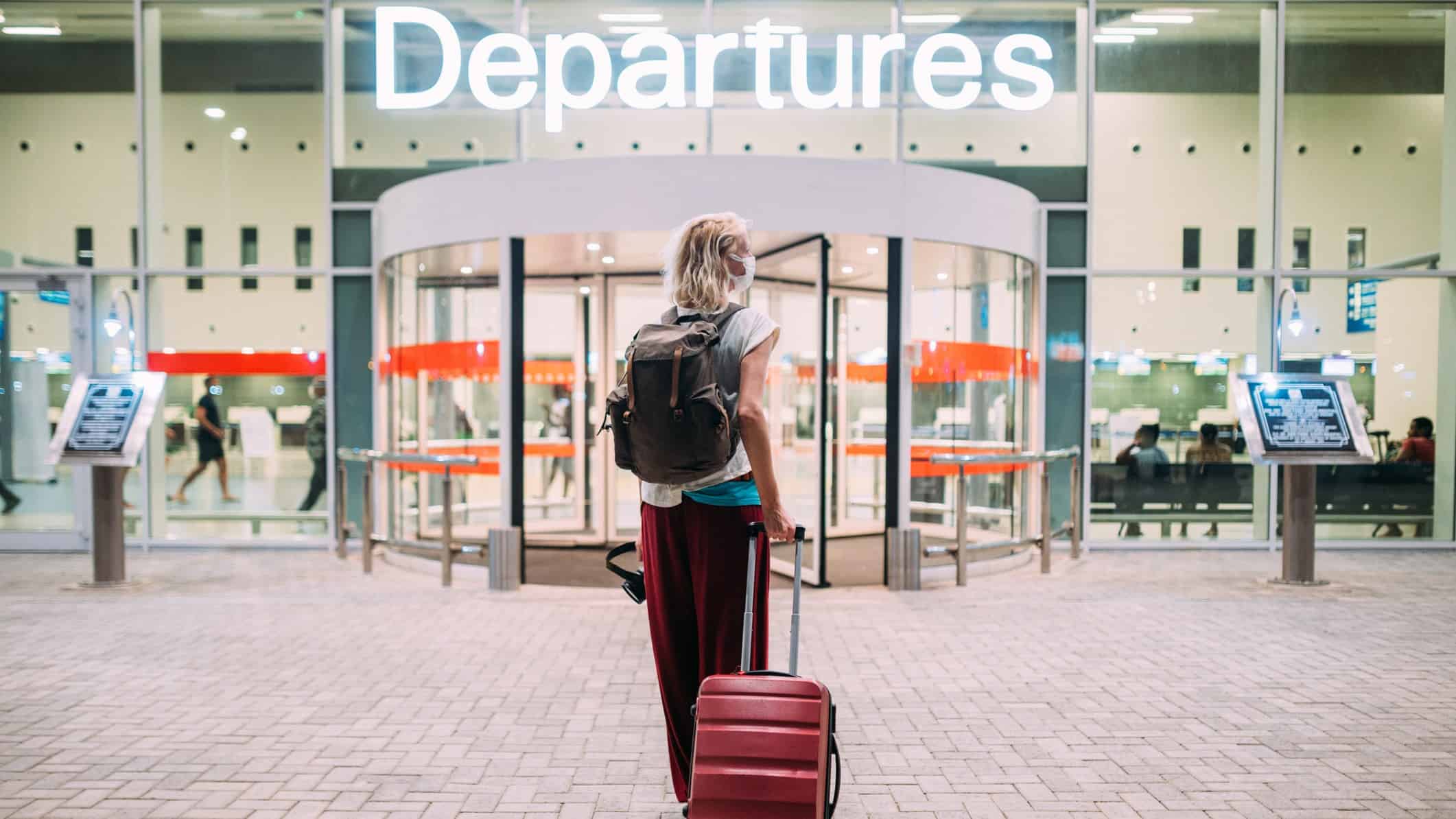 Woman at a departure terminal at an airport.