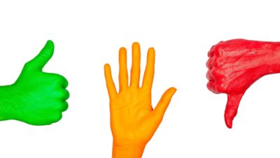 three hands painted red, amber and green making different signals