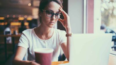 Worried ASX share investor looking at laptop screen