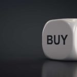 Buy and sell written on a white cube.