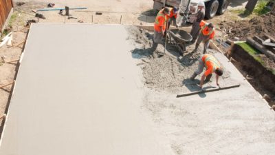 Workers working with cement to make concrete.