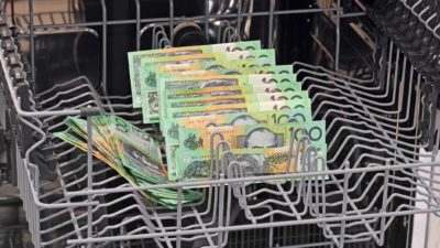 $100 notes in a dishwasher, symbolising clean cash or money laundering